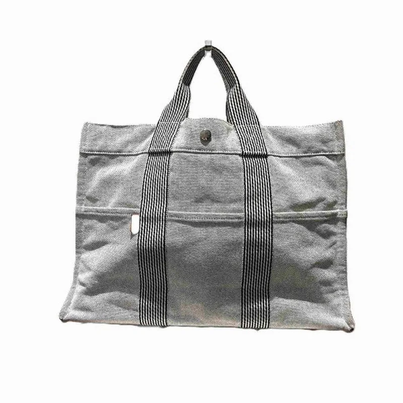 Handle bags with neutral tones for versatility -Hermes  Canvas Handbag Tote Bag (Pre-Owned)